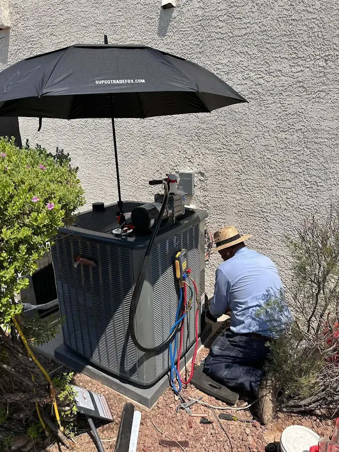 HVAC technician performing outdoor AC maintenance in Patterson